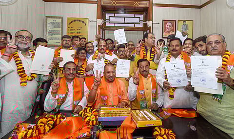Chief Minister Yogi Adityanath pose for a photograph with the newly elected BJP MLC's at Vidhan Bhawan in Lucknow on Thursday. | PTI