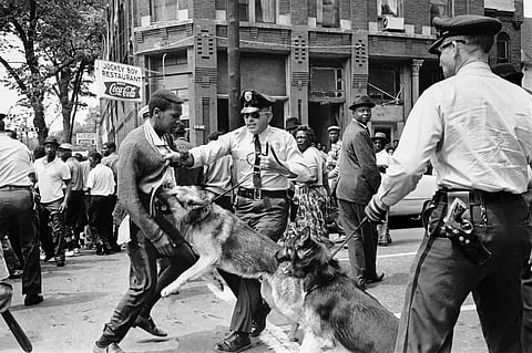 In this May 3, 1963 file photo, a 17-year-old civil rights demonstrator, defying an anti-parade ordinance of Birmingham, Ala., is attacked by a police dog. On the afternoon of May 4, 1963, during a meeting at the White House with members of a political group, President Kennedy discussed this photo, which had appeared on the front page of that day's New York Times. (File | AP)