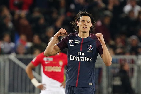 PSG striker Edison Cavani celebrates after scoring his side first goal during the League Cup final soccer match against Monaco in Bordeaux. | AP