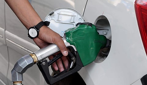 Petrol pump attendant filling the tank of a Car with petrol in New Delhi. 