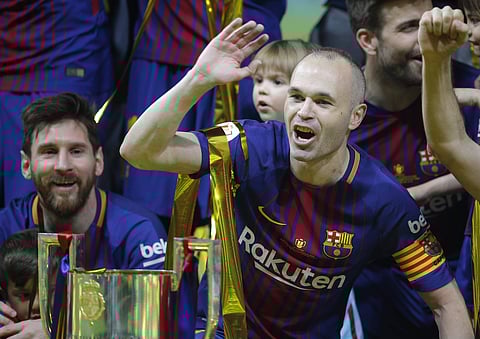 FC Barcelona's Andres Iniesta, right, and Lionel Messi celebrate during an award ceremony after defeating Sevilla 5-0 in the Copa del Rey final soccer match at the Wanda Metropolitano stadium in Madrid, Spain, Saturday, April 21, 2018. | AP
