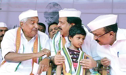 Ramesh Chennithala holds a kid during his 24-hour fast demanding a CBI probe into the custodial death of Sreejith, in Kochi on Monday. | Melton Antony