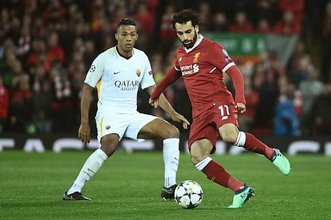 Liverpool's Egyptian midfielder Mohamed Salah (R) controls the ball during the UEFA Champions League first leg semi-final football match between Liverpool and Roma at Anfield stadium in Liverpool, north west England on April 24, 2018. | AFP