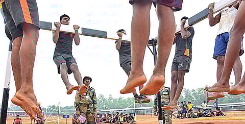 Candidates perform chin-ups at the Army recruitment rally which began at the Pangode military station, Thiruvananthapuram. | B P Deepu