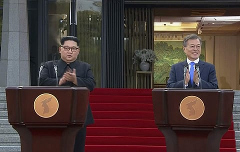 North Korean leader Kim Jong Un and South Korean President Moon Jae-in applaud at the end of their joint announcement. | AP