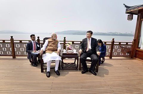 Prime Minister Narendra Modi with Chinese President Xi Jinping inside a house boat in Wuhan s East Lake China on Saturday. | PTI