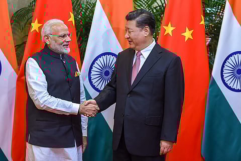 Prime Minister Narendra Modi shakes hands with Chinese President Xi Jinping during his visit in Wuhan China on Friday. | PTI