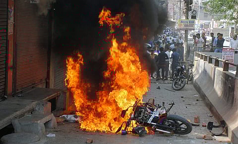 A bike set on fire by a group of protesters during 'Bharat Bandh' call given by Dalit organisations against the alleged dilution of Scheduled Castes / Scheduled Tribes Act. (File | PTI)