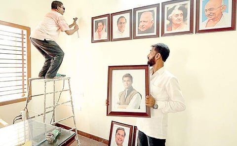 Workers going hammer and tongs to fix a photo frame at Shivamogga District Congress office on Monday. Party chief Rahul Gandhi who is on a two-day trip to the central Karnataka region will inaugurate the office in Shivamogga on Tuesday | Shimoga Nandan