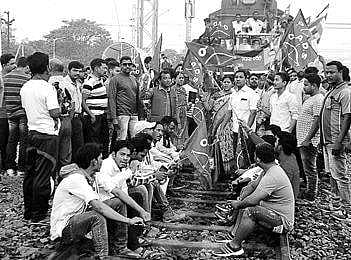 Agitators protest on tracks at Sambalpur Railway Station and closed business establishments in Rourkela on Monday | EXPRESS