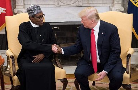 US President Donald Trump and Nigerian President Muhammadu Buhari shake hands during a meeting in the Oval Office of the White House in Washington, DC, on April 30, 2018. | AFP