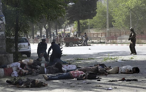 Victims in double explosions lie on the ground in Kabul, Afghanistan, Monday, April 30, 2018. (Photo: AP)