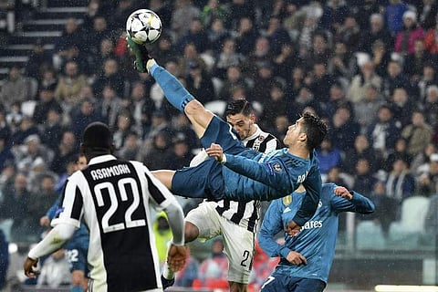 Real Madrid's Portuguese forward Cristiano Ronaldo (C) scores during the UEFA Champions League quarter-final first leg football match against Juventus | AFP