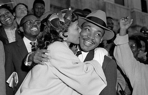 In this March 22, 1956, file photo, the Rev. Martin Luther King Jr. is welcomed with a kiss by his wife, Coretta, after leaving court in Montgomery, Ala. King was found guilty of conspiracy to boycott city buses in a campaign to desegregate the bus system