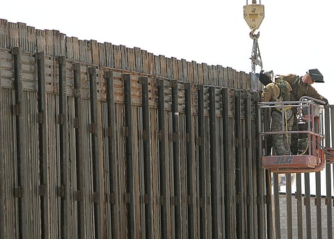 In this June 13, 2006, file photo, Utah National Guard soldiers work on extending a border fence in San Luis, Ariz. (File | AP)