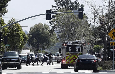 Officers walk near a YouTube office in San Bruno, California, Tuesday, April 3, 2018 (AP)
