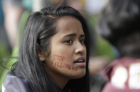 Lucy Saile joins others outside the office of Sacramento County District Attorney Anne Marie Schubert calling for the indictment of the two Sacramento police officers who shot and killed Stephon Clark, during a rally Wednesday, April 4, 2018, in Sacrament