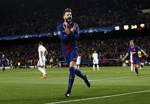 Barcelona's Gerard Pique celebrates after scoring the third goal of his team during a Champions League quarter-final between FC Barcelona and Roma (AP)