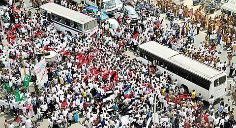 DMK cadre blocking the Labour Statue area in the city on Thursday; and (below) party working president M K Stalin being carried away by the police during the protest | Express