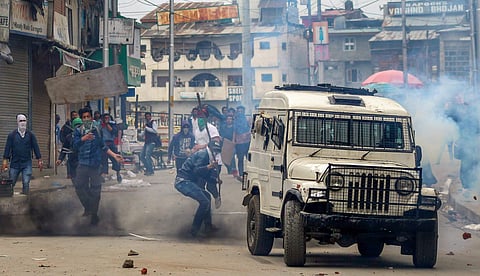 Students damage a police vehicle during clashes over killings in the recent encounters at Lal Chowk in Srinagar on Thursday. (PTI)