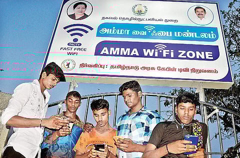 Youth using the Amma wi-fi facility, after Chief Minister Edappadi K Palaniswami launched the facility, near Labour Statue on the Marina in the city on Friday | D SAMPATH KUMAR