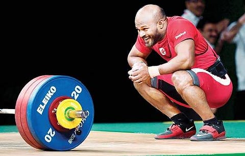 Sathish Sivalingam reacts after striking gold in the men’s 77kg weightlifting event in Gold Coast on Saturday | AFP