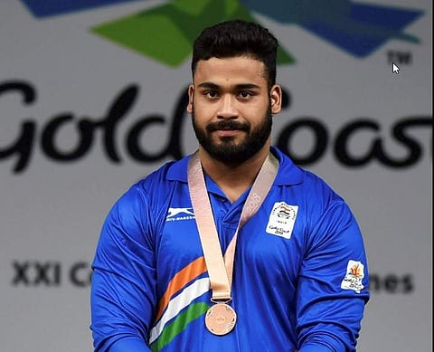 India's bronze medal winner Vikas Thakur during medal ceremony of the men's 94kg Weightlifting category | PTI