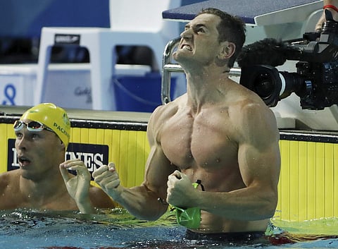 Van der Burgh celebrated wildly by punching the water before climbing on to the lane rope and pumping his fists in delight. | AP