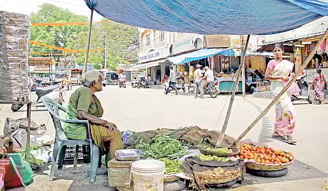 An old woman selling vegetables under a plastic sheet at Lal Bazar in Trimulgherry in Secunderabad | sathya keerthi