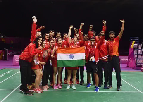 India badminton players hold tricolour as they celebrate India's win in mixed-team badminton event final at Commonwealth Games 2018 in Gold Coast on Monday. | PTI