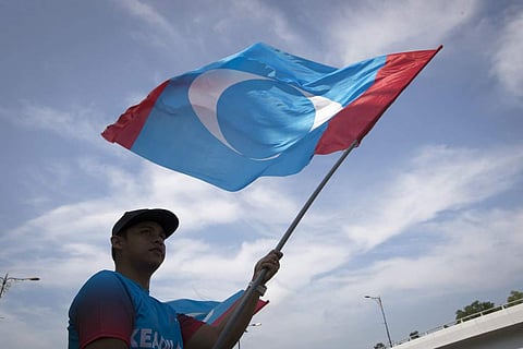 0 1 2 3 4 5 6 7 A supporter waves a flag of the People's Justice Party outside palace in Kuala Lumpur, Malaysia. | AP