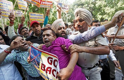 Activists from Swadeshi Jagran Manch, a wing of RSS, scuffle with police during a protest. (Photo | Reuters)