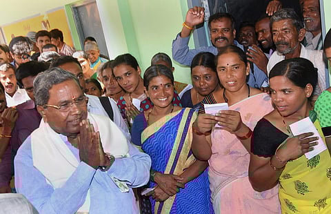 Karnataka Chief Minister Siddaramaiah greets his supporters after voting at Hundi village in Mysore on Saturday. | Express Photo
