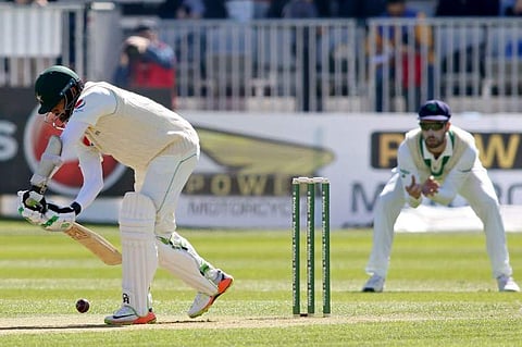Pakistan's Azhar Ali scores a single off the first ball during play on day two of Ireland's inaugural test match against Pakistan at Malahide cricket club, in Dublin on May 12, 2018. | AFP