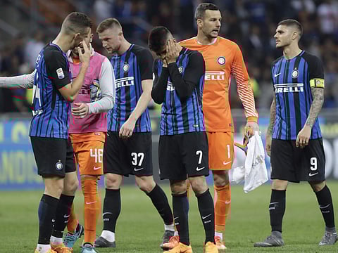Inter Milan players leave the pitch at the end of the Serie A match between Inter Milan and Sassuolo at the San Siro stadium in Milan. (AP)