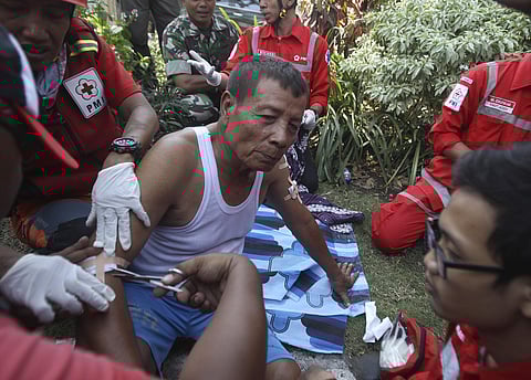 Paramedics tend to a man injured in a church explosion in Surabaya, East Java, Indonesia, Sunday, May 13, 2018.(AP)