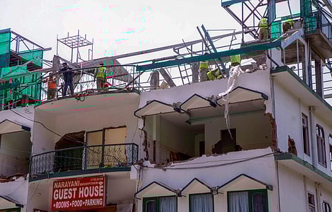 Demolition of unauthorised construction under progress at Kasauli in Solan district. | PTI File Photo
