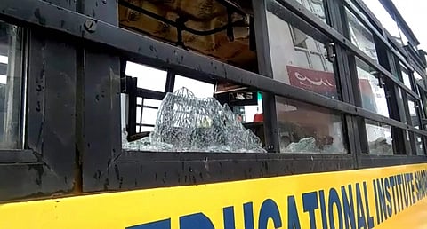 The damaged school bus which was attacked by stone-pelters at Zavoora area in Shopian. (PTI)