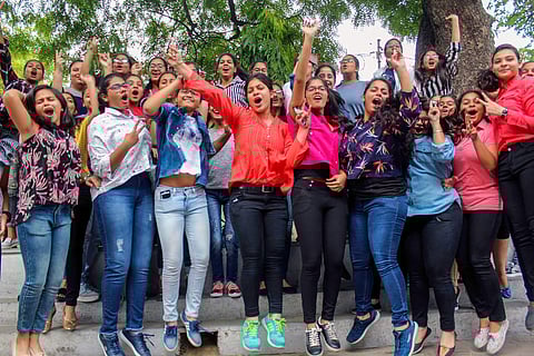 Students pose for a photograph as they celebrate after the Indian Certificate of Secondary Examination ICSE results of class 10th and 12th were declared in Meerut on Monday. | PTI