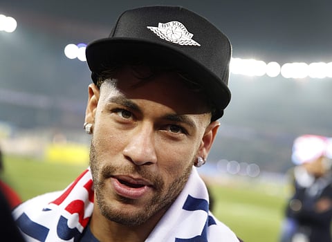 PSG player Neymar looks at the photographer during celebrations for clinching the French League One title after the soccer match between Paris Saint-Germain and Stade Rennais on May 12 (AP Photo)