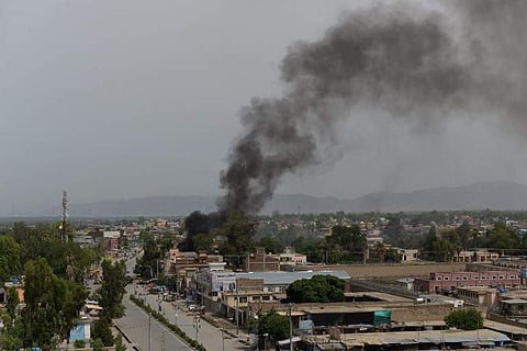 Smoke rises from a building during an ongoing attack between Afghan security force and suicide attackers at a government building in Jalalabad. | AFP