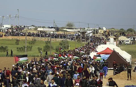 Palestinians attend a demonstration near the Gaza Strip border with Israel in eastern Gaza City. | AP