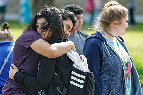 Parents mourn after 10 students were killed after their classmate opened fire on them in a school in Texas (AP Photo)