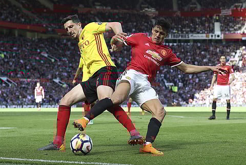 Watford's Craig Cathcart, left, and Manchester United's Alexis Sanchez battle for the ball during their English Premier League soccer match at Old Trafford, Manchester, England, Sunday, May 13, 2018. | AP