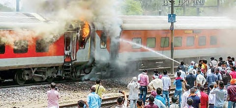 Fire tenders dousing the flames billowing out of two coaches of AP Express | PTI