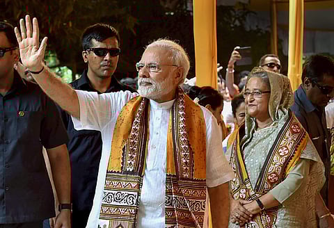 Prime Minister Narendra Modi waves as his Bangladeshi counterpart Sheikh Hasina looks on after attending convocation of the Visva Bharati University at Santiniketan on Friday. (Photo | PTI)