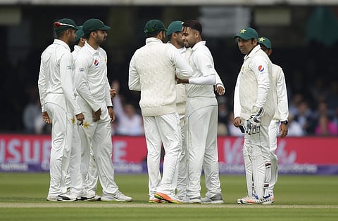 Pakistan's Faheem Ashraf, second right, celebrates with teammates after taking the wicket of England's Jonathan Bairstow during the first day of play of the first test cricket match between England and Pakistan at Lord's cricket ground in London, Thursday
