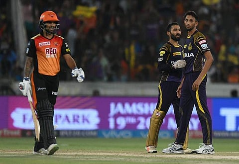 Kolkata Knight Riders cricketer Prasidh Krishna (R) looks on after taking the wicket of Sunrisers Hyderabad cricketer Shikhar Dhawan (L) during the 2018 Indian Premier League (IPL) Twenty20 cricket match between Sunrisers Hyderabad and Kolkata Knight Ride