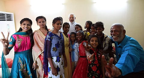 Prime Minister Narendra Modi with D Prakash Rao and his school children at Cuttack on Saturday. | EPS