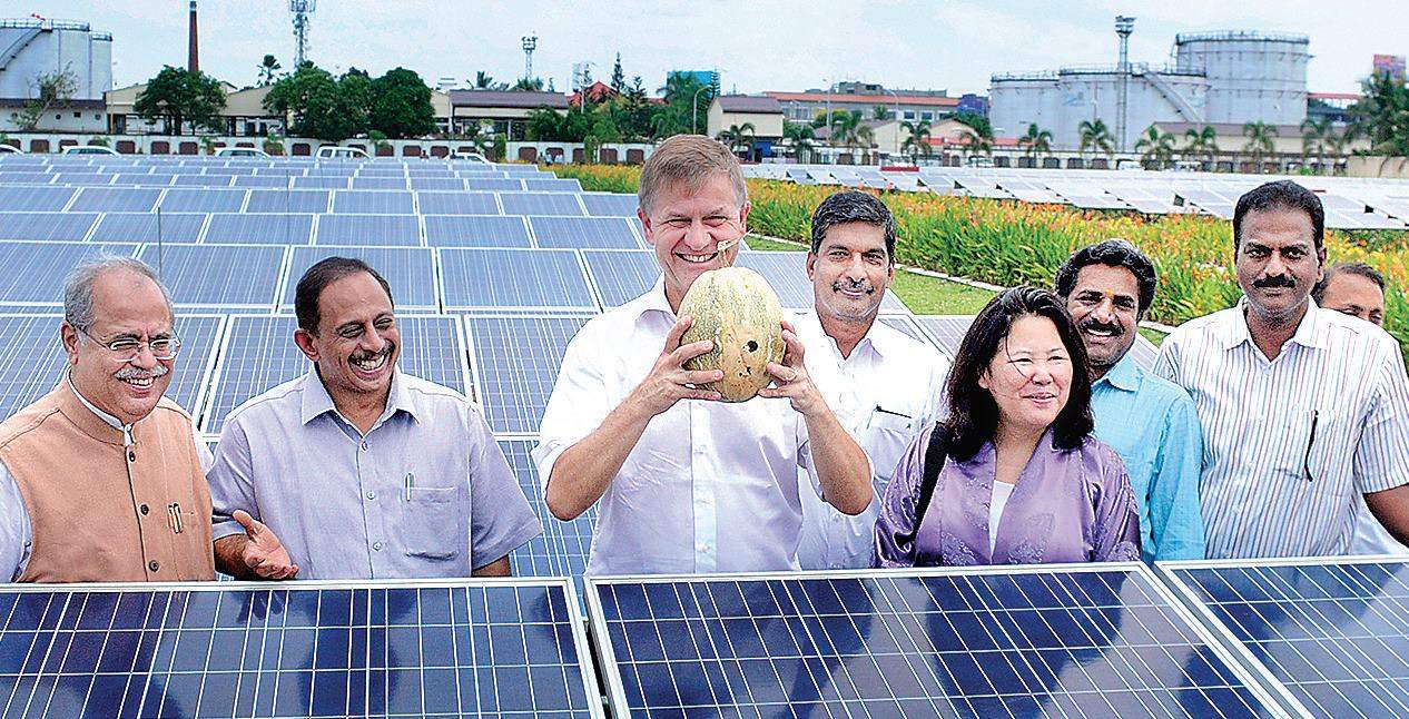 United Nations Environment Programme executive director Erick Solheim with a pumpkin cultivated on the ground beneath the solar power plant at the Cochin International Airport, on Saturday | A Sanesh